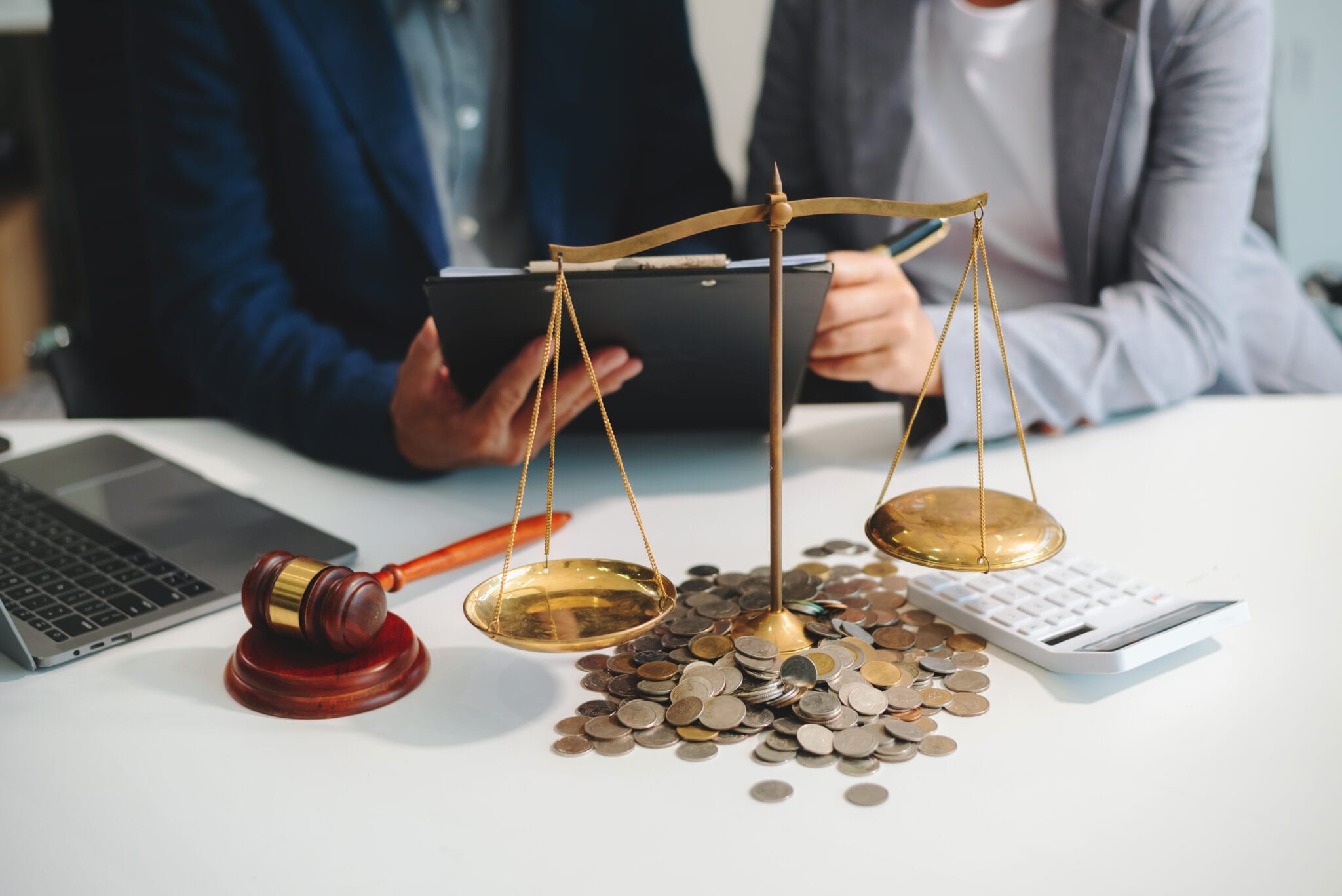 male lawyer in the office with brass scale on wooden table. just