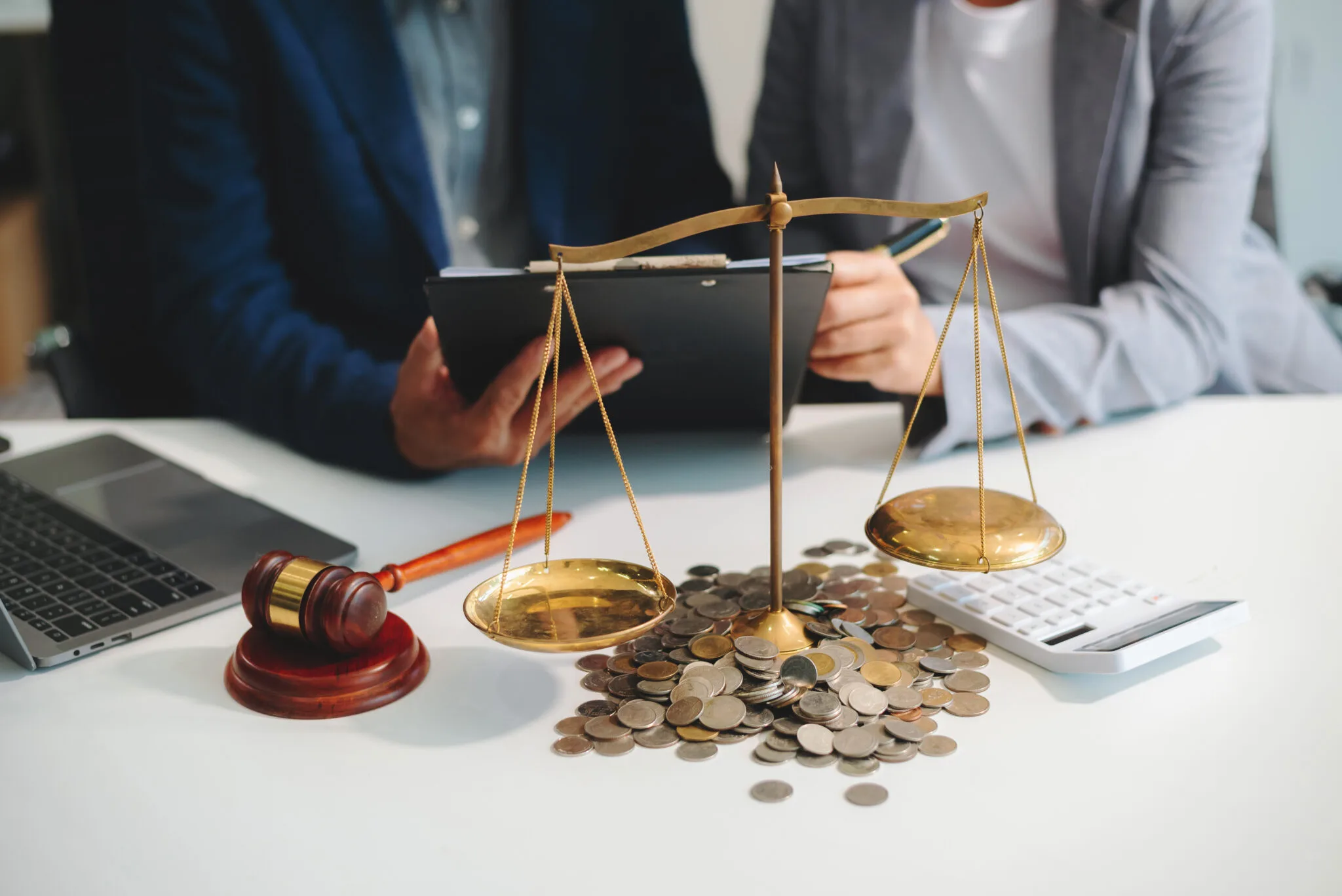 male lawyer in the office with brass scale on wooden table. just